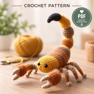 May include: A crochet pattern PDF for a scorpion toy. The scorpion is crafted with yellow, orange, and brown yarn, featuring a curved tail with a black tip, two large pincers, and eight legs. The text CROCHET PATTERN and PDF INSTANT DOWNLOAD appear.