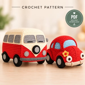 May include: A crochet pattern PDF instant download featuring two handmade vehicles: a red and cream van with grey windows and a red car with light blue windows, a yellow flower detail, and white circular headlights on a light wooden surface.