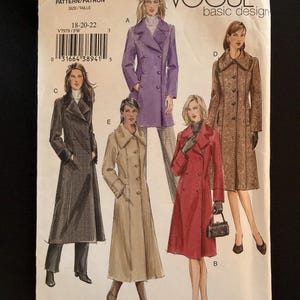 May include: A Vogue Basic Design sewing pattern envelope V7979 for sizes 18-20-22. The front displays illustrations of five different long coats in purple, beige, red, and two shades of brown, featuring various collar styles, button closures, and lengths.