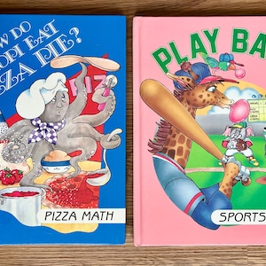 May include: Two children's books side-by-side. The blue book has an octopus chef on the cover with the text "How Do Octopi Eat Pizza Pie?" and "Pizza Math." The pink book has a giraffe playing baseball with the text "Play Ball" and "Sports Math."
