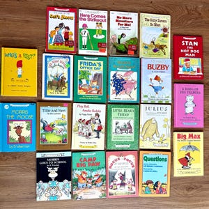 May include: A collection of vintage children's books with colorful covers. Titles include "The Case of the Cat's Meow", "Who's a Pest?", "Morris the Moose", and "Big Max". The books are arranged on a wooden surface.