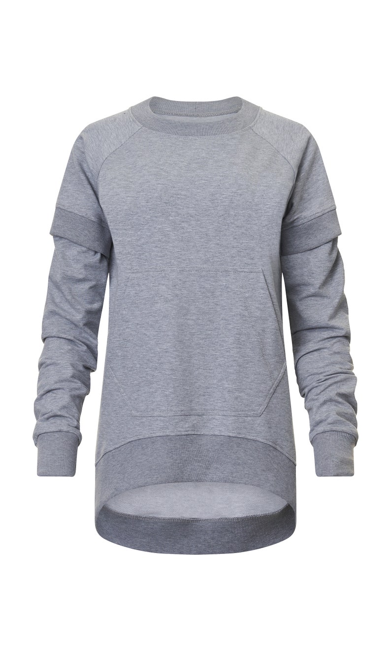 May include: A gray long-sleeved sweatshirt with a kangaroo pocket and a slightly longer back hem.