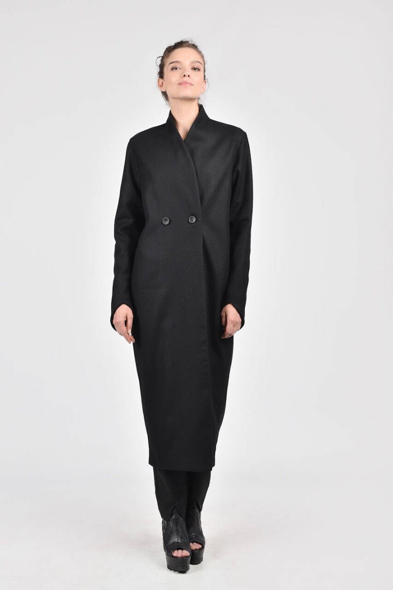 May include: A long black coat with a double-breasted closure and a wide collar.