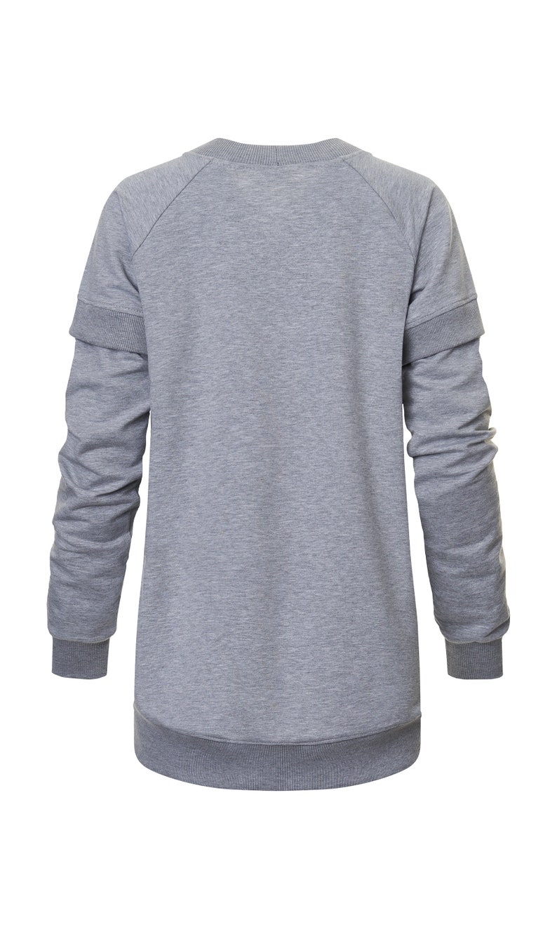May include: A gray long-sleeved sweatshirt with a ribbed crew neck and cuffs. The sweatshirt has a double layer on the sleeves.