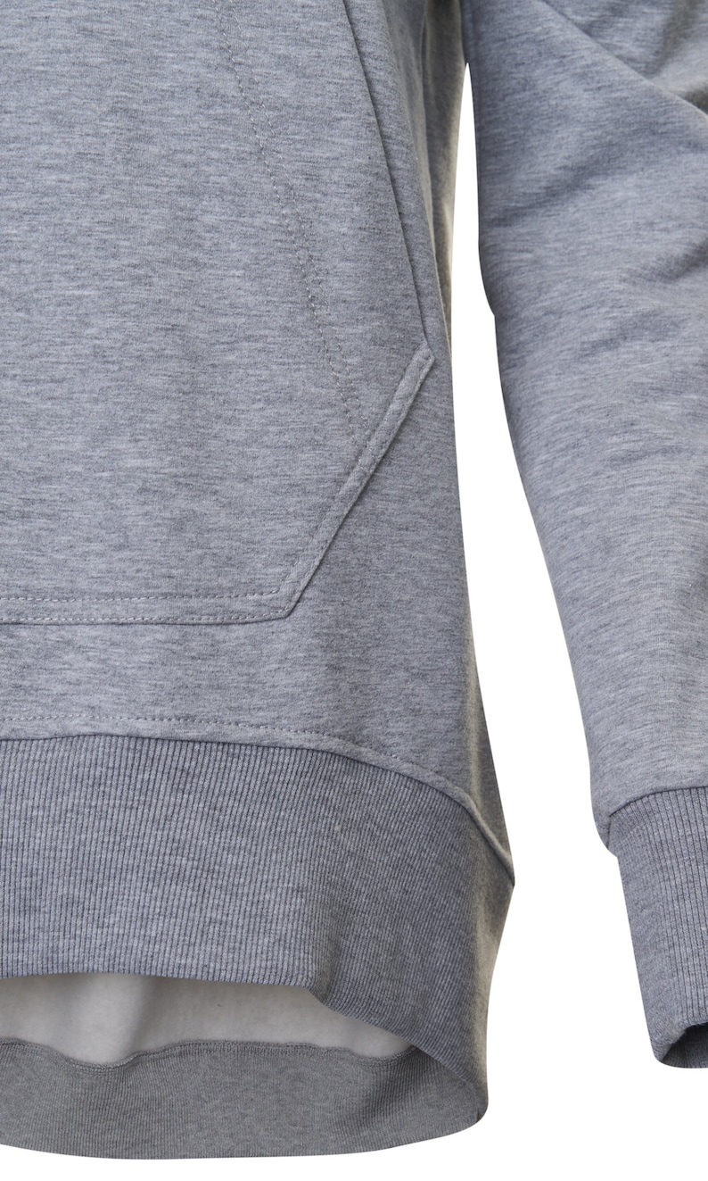 May include: A gray long-sleeved sweatshirt with a kangaroo pocket and a ribbed hem.