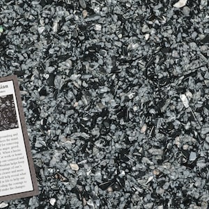 May include: A close-up view of a collection of snowflake obsidian stones, with a mix of black and gray colors. A small card with the text "Snowflake Obsidian" is visible, along with a description of the stones.