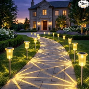 May include: A 15 pack of solar-powered pathway lights with cylindrical, ribbed glass shades and silver-toned metal stakes. Each light emits a warm, glowing illumination that casts geometric, star-shaped patterns across the stone walkway.