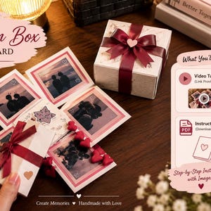 May include: A DIY explosion box photo card kit featuring a white gift box with a maroon ribbon, multiple square photo panels, and a small inner box. Includes text labels for a video tutorial and instruction PDF from the Sana Digital shop.