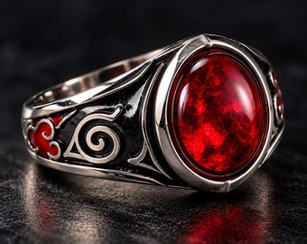 Può includere: Un anello in metallo color argento con una grande pietra preziosa rossa ovale e sfaccettata al centro. La fascia è decorata con dettagli in smalto nero, tra cui un simbolo a spirale e forme rosse simili a nuvole incise sui lati.