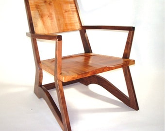May include: A wooden chair with a light brown seat and dark brown legs. The chair has a unique design with a curved back and angled legs.