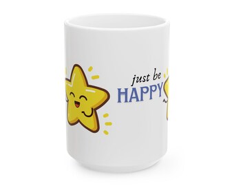 May include: A white ceramic mug featuring a yellow cartoon star character with a smiling face and the text "just be HAPPY" printed in black and blue lettering. The star is surrounded by small yellow dash marks indicating a glowing effect.