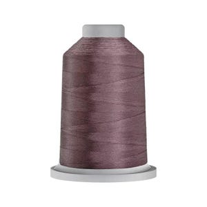 May include: A spool of dusty mauve sewing thread featuring a cylindrical plastic core with a flat top and base. The thread is tightly wound in a smooth, uniform layer around the central column, displaying a consistent matte texture.