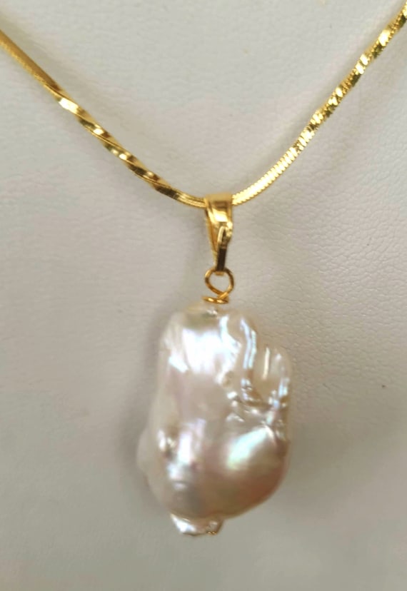 AA+ Baroque pearl pendant 20 x 15mm approx. High luster pearl. Each piece is awesome and unique. Chain not included. Gift bagged for you.