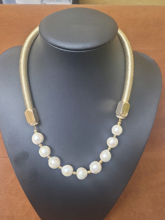 Freshwater pearl and golden yarn tube necklace. Has 9 beautifully graduated baroque pearls as front detail. Beautiful, classy and different!