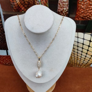 Large baroque pearl pendant 50 x 18mm approx. High luster pearl. This piece is awesome & unique. Very beautiful. Pendant with 18 inch chain.