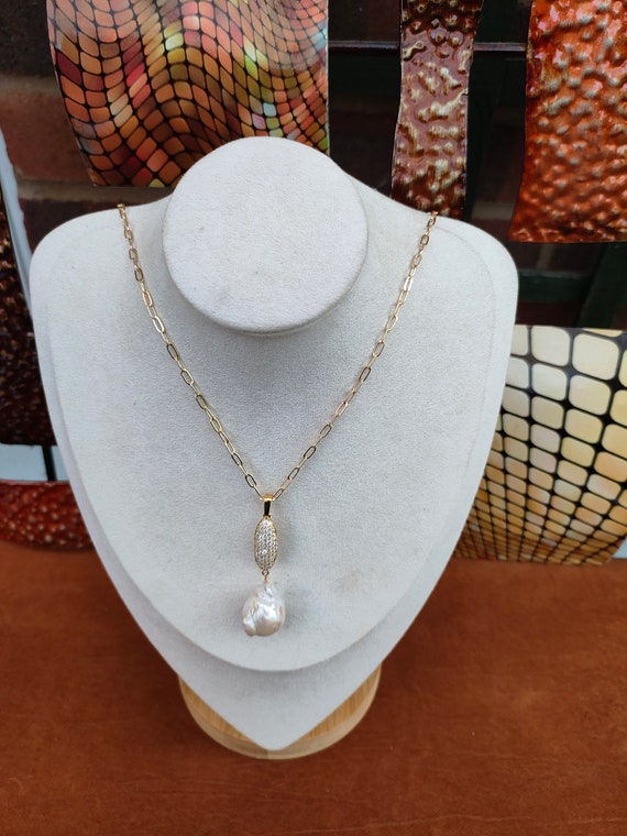 Large baroque pearl pendant 50 x 18mm approx. High luster pearl. This piece is awesome & unique. Very beautiful. Pendant with 18 inch chain.