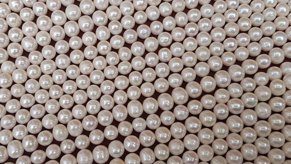 6mm  ivory baroque nugget freshwater pearls. Each strings is 15.5 inches. High luster, almost round pearls. 65 beads approx. on each strand