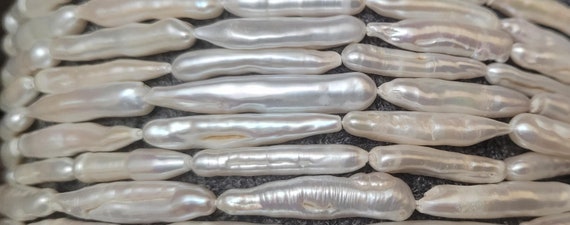 Biwa souffle baroque  ivory pearls 25x5mm approx. Each strings is 15 inches long. High luster, beautiful quality pearls.