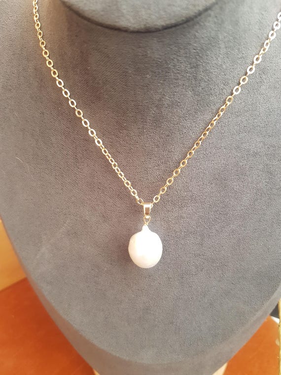 These 18x 12mm baroque pearls form a triple pendant, creating a unique three-in-one necklace. Chain included, earrings are optional.