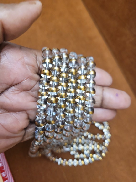 Clear glass beads with antique gold lining. Unique, vintage crystal. Beads are 8mm. 14.5 inch strand.