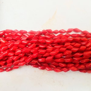 Coral resin red beads. Each strand is 18 inches long. These beads are 8 x 4mm approx.