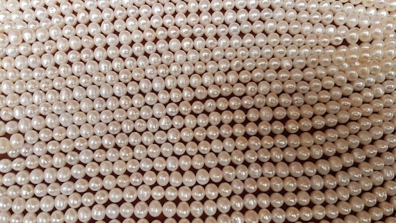 8mm  ivory almost round freshwater pearls. Each strings is 15 inches. High lustre. 52 beads per strand.