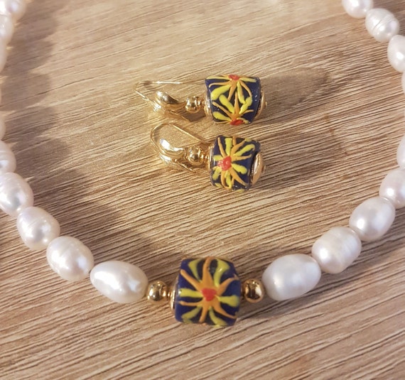 Baroque pearls with Ghanaian glass bead front detail and earrings to match. "Blend of cultures" design.