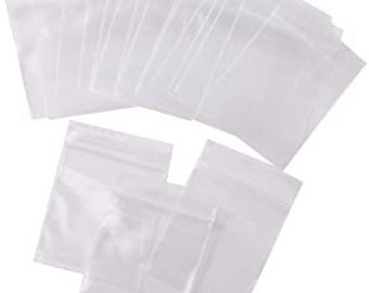 May include: A collection of small, clear plastic bags with resealable zip-top closures. The bags are transparent, rectangular, and arranged in a loose pile, showing their flexible material and functional design for storage and organization.
