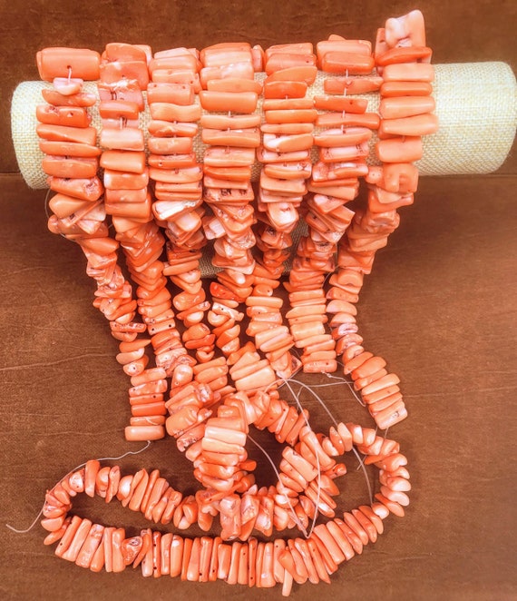 Salmon coral beads. Beads are half barrels 25mm x 15mm  with smooth texture. Length is 17 inches. You will get approx. 50 large beads.