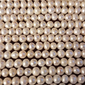 AAAA 6-7 mm oval cultured freshwater pearl strings. Each strings is15.5 inches (39cm). High luster beads.