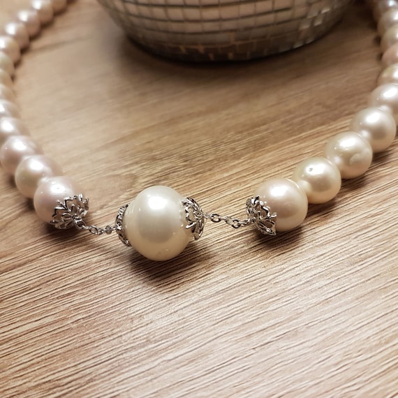 AAA Freshwater pearl necklace. 12mm round  beads with large front baroque 20mm approx.   18 inches long.