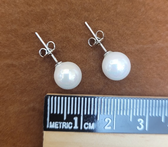 Freshwater pearl earrings. They have a very high luster, 8mm in diameter, 925 Sterling silver posts and butterflies. Classic & minimalist.
