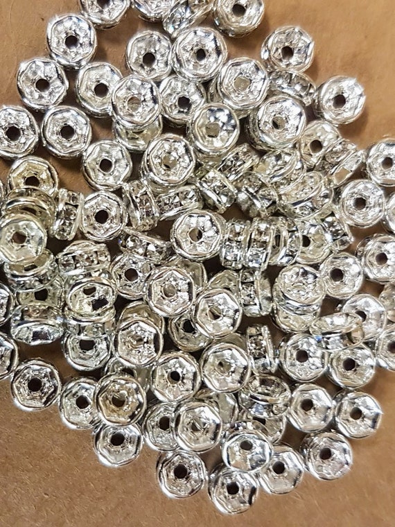 5mm silver plated rondelle spacer beads with clear rhinestones. Pack of 50.