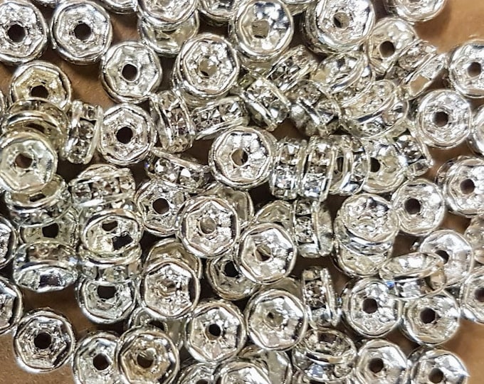 5mm silver plated rondelle spacer beads with clear rhinestones. Pack of 50.