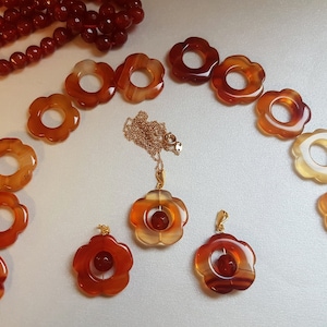 Beautiful carnelian floral pendant on chain with gold-plated bail. Due to uniqueness of coloring, shades may differ slightly.