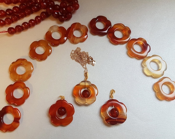 Beautiful carnelian floral pendant on chain with gold-plated bail. Due to uniqueness of coloring, shades may differ slightly.