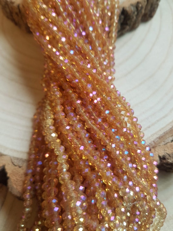 3x4mm Chinese crystal beads. Gold AB effect, on string, 19 inches with ***145*** rondel spacer beads. Super fast delivery from the UK!!!