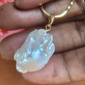 AAA Baroque pearl pendant 20 x 15mm approx. High luster pearl. Each piece is awesome and unique. Chain not included. Gift bagged for you.