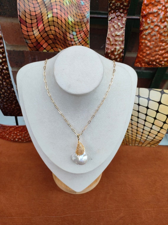 Large baroque pearl pendant 30 x 28mm approx. High luster pearl. This piece is awesome & unique. Very beautiful. Pendant with 18 inch chain.