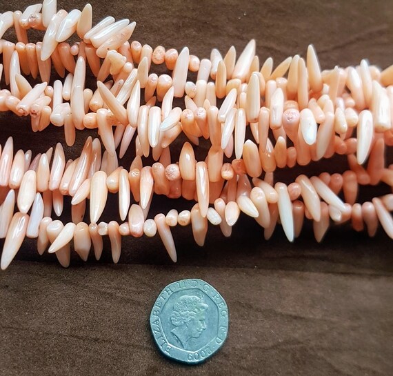 Natural coral pink polished coral gemstone beads. 15.5 Inches strand. Very beautiful beads.