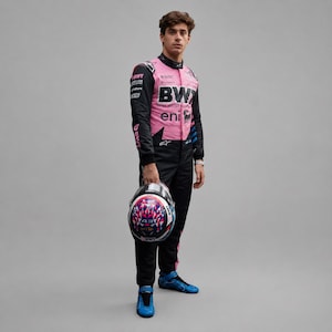 May include: A racing suit featuring a pink torso with black sleeves and black trousers, adorned with various sponsor logos including BWT, MSC, and eni. The suit is paired with a matching helmet displaying a geometric pattern and the number 43.