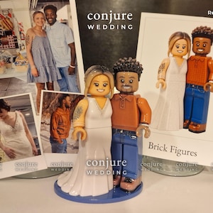 May include: A custom figurine set featuring two plastic figures resembling a couple, with one figure in a white gown and the other in an orange polo shirt and blue jeans, standing on a blue circular base, displayed with printed photographs.