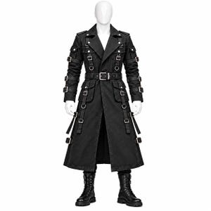 May include: A black long coat featuring a notched lapel, a waist belt with a silver buckle, and multiple straps with silver buckles on the sleeves and front. The coat includes two chest pockets, two waist pockets, and silver D-ring hardware details.