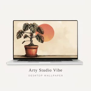 May include: A silver laptop displaying a digital illustration of a potted monstera plant with large green leaves and a twisted stem, set against a pale background with a large orange sun. Below the laptop, the text reads Arty Studio Vibe.