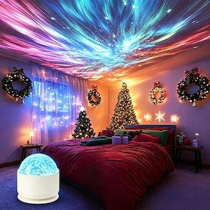 May include: A white spherical galaxy projector lamp sits in the foreground, casting a vibrant, swirling nebula of blue, pink, and purple light with scattered white stars across the ceiling of a bedroom decorated with Christmas trees and wreaths.