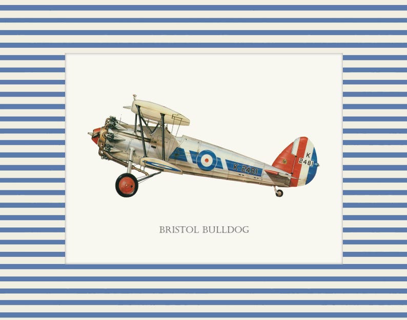 May include: An illustration of a vintage Bristol Bulldog biplane, featuring a silver fuselage, red and blue accents, and a roundel. The plane is set against a cream background, framed by a blue and white striped border. The text "BRISTOL BULLDOG" is below the plane.