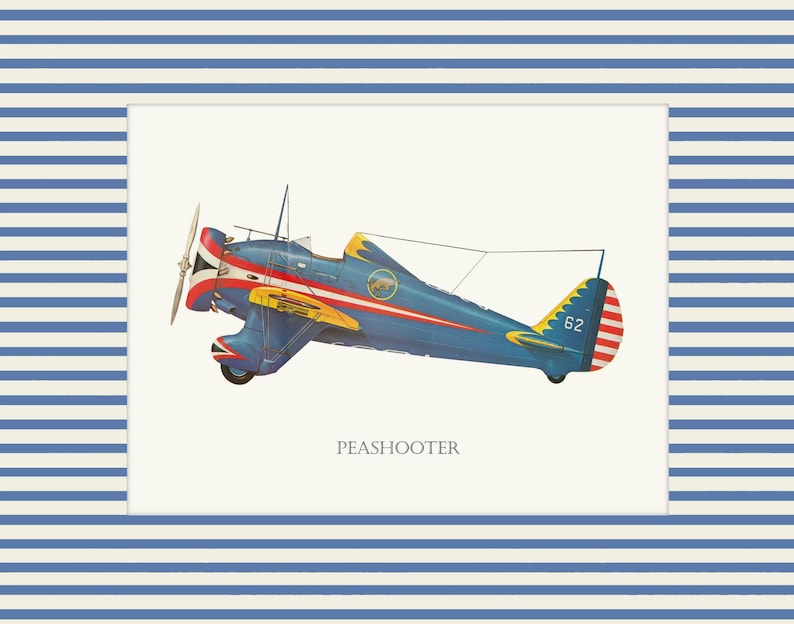 May include: A vintage illustration of a blue and yellow Peashooter airplane with red and white accents. The plane is set against a cream background and framed by a blue and white striped border. The word "PEASHOOTER" is printed below the plane.