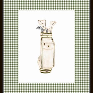 May include: A white golf bag with brown leather accents and golf clubs sticking out of the top. The bag is sitting on a white background.