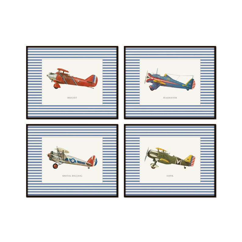 May include: Four framed prints featuring vintage airplane illustrations. Each print has a blue and white striped background and a black frame. The airplanes are in various colors, including red, blue, green, and yellow, with the names of the planes printed below.