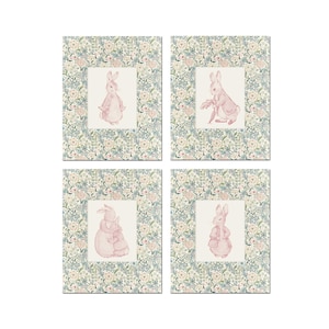 May include: Set of four framed prints featuring a pink rabbit in different poses. Each print has a floral border with a white background.